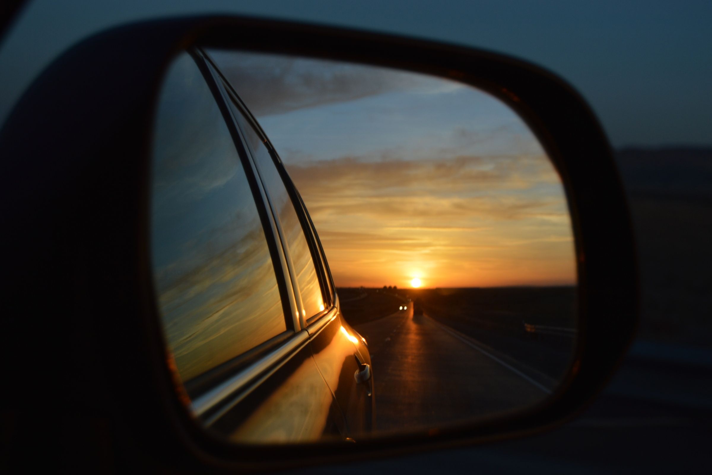 Sun setting in the sideview mirror